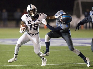 CCH ball carrier Devonte Ballantyne tries to shake off Lucas tackler Will Adam during the WOSSA senior football championship game against CCH at TD Stadium in London. Derek Ruttan/The London Free Press/Postmedia Network