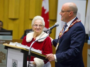 Outgoing mayor Matt Brown introduces "Mrs. Claus," Jeanne Alpaerts who at 87 years old is with the Angels of the Night program and was being recognized for Senior of the Year at this council's last meeting.  Mike Hensen/The London Free Press/Postmedia Network