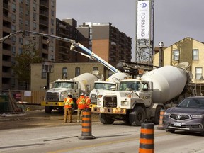 Cement trucks line up on Richmond Street to deliver a constant stream of concrete for the foundation being poured on Wednesday for a 32-storey Old Oak Properties apartment tower just north of Dufferin Avenue. (Mike Hensen/The London Free Press)