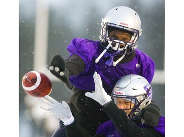 Bleska Kambamba knocks the ball away from safety Daniel Valente Jr., the intended receiver, Wednesday during the Mustangs' last practice before flying to Quebec City for the Vanier Cup against Laval Saturday. Mike Hensen/The London Free Press