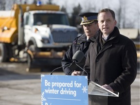 Jeff Yurek, minister of transportation, is joined by Chief Superintendent John Cain of OPP West Region on Friday to announce drivers can now track the location of snow plows  and salt trucks on provincial roads and highways on all of the Ontario 511 platforms.  (Derek Ruttan/The London Free Press)