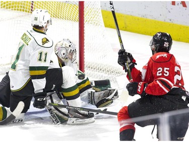 Knights forward Connor McMichael can't block a shot by Owen Sound Attack shooter Cade Robinson but London goalie Jordan Kooy is there to make the save during the first period of their OHL game at Budweiser Gardens on Friday night.  (Derek Ruttan/The London Free Press)