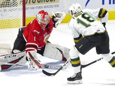 Owen Sound Attack goalie Mack Guzda stops London Knight forward Liam Foudy in close during the first period of their OHL game at Budweiser Gardens on Friday night.  (Derek Ruttan/The London Free Press)
