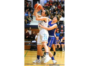 Lucas's Melanie Plaskett gets fouled by Brantford Collegiate Institute's Madison McGregor during their quarterfinal match at home Friday during the OFSAA AAA tournament. Lucas led early, fell behind in the second and third quarter and pulled out a squeaker winning 55-53 and moving on to the final four. (Mike Hensen/The London Free Press)