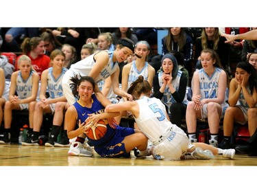 Lucas's Taya Spears and Haley Willits dig for the ball against Taylor Hill of Brantford Collegiate Institute during their quarterfinal match at home Friday during the OFSAA AAA tournament. Lucas led early, fell behind in the second and third quarter and pulled out a squeaker winning 55-53 and moving on to the final four. (Mike Hensen/The London Free Press)