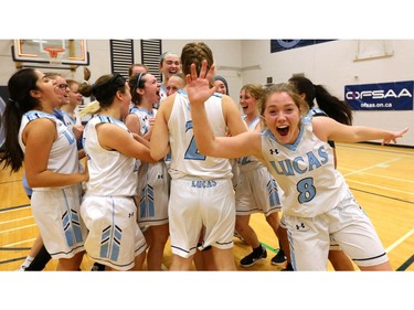Lucas players celebrate with Bri Davis mugging for the camera after winning their quarterfinal game 55-53 over Brantford Collegiate at home Friday during the OFSAA AAA basketball tournament. Photo taken Nov. 23, 2018. (Mike Hensen/The London Free Press)