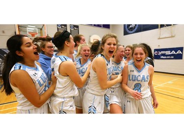 Lucas players celebrate after winning their quarterfinal 55-53 over Brantford Collegiate at home Friday during the OFSAA AAA tournament. Lucas led early but fell behind in the second and third quarter before pulling out a squeaker win and moving on to the final four. (Mike Hensen/The London Free Press)