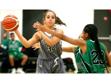 Eliana Faysal of the Mother Teresa Spartans passes away from a double team set up by Ajax's Dennis O'Connor during their OFSAA AA quarterfinal game at John Paul II  on Friday. The Spartans will have home floor for the semifinal at 10:30 a.m. Saturday but it will be against top-seeded Wallaceburg, who beat Theriauly 68-47 in the quarters.  (Mike Hensen/The London Free Press)