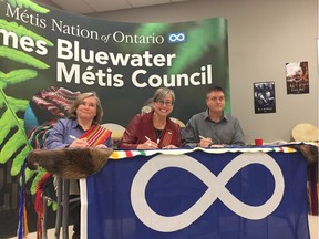 The charter for the Thames Bluewater Metis Council was officially signed on Saturday, establishing the group among 30 other Metis Nation of Ontario councils. Council president Kathleen Anderson, left, Metis Nation of Ontario president Margaret Froh and regional councillor Peter Rivers signed the charter at a ceremony held in London. (Jane Sims/The London Free Press)