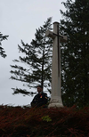 Canadian Armed forces bugler Cpl. Ross Bligh stands beneath the cross of sacrifice at St. Symphorien Military Cemetery outside Mons, Belgium. It is where the last Commonwealth casualty of the war, Canadian George Price, is buried. (Jennifer Bieman/The London Free Press)