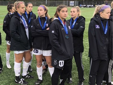 Western Mustangs players are sombre waiting for medal presentations after their 1-0 loss to the Ottawa Gee-Gees in the Ontario University Athletics women's soccer championship game Sunday at Western. (Paul Vanderhoeven/The London Free Press)