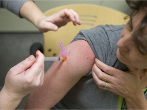 A public health nurse administers a flu shot at the Middlesex-London Health Unit in London in this file photo. (The London Free Press)