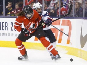 Canada's national women's team member Rebecca Johnston and U.S. women's national team member Michelle Picard fight for the puck during a series in 2013. The teams will have another series early in 2019, which will include a stop in London.(Postmedia Network file photo)