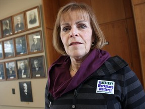 Coun. Anne Marie Gillis poses outside council chambers with a sticker she's been wearing since her recent mayoral campaign. She was defeated by Sarnia Mayor Mike Bradley. Other members of city council joined her Monday in wearing the stickers, alluding to workplace investigations in 2016 that found Bradley bullied and harassed city staff. Tyler Kula/Sarnia Observer/Postmedia Network