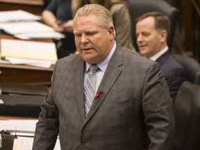 Ontario Premier Doug Ford rises to answer a question during Question Period at the Ontario Legislature on Thursday November 29, 2018. THE CANADIAN PRESS/Chris Young