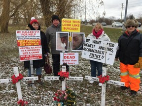 Almost every Saturday for seven months, the families of Justin Struthers and James Pigeau have gathered and protested outside Elgin-Middlesex Detention Centre. The two men died about a year ago at the jail. Bundled up against the cold, from left, are Judy Struthers, Glen Struthers, Janice Pigeau and Roger Pigeau. (RANDY RICHMOND, The London Free Press)