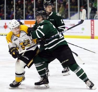 London Knights' Andrew Perrott (24) checks Sarnia Sting's Jamieson Rees (39) in the first period at Progressive Auto Sales Arena in Sarnia, Ont., on Sunday, Dec. 30, 2018. (Mark Malone/Chatham Daily News/Postmedia Network)