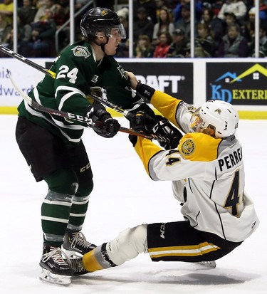 London Knights' Andrew Perrott (24) knocks down Sarnia Sting's Jacob Perreault (44) in the first period at Progressive Auto Sales Arena in Sarnia, Ont., on Sunday, Dec. 30, 2018. (Mark Malone/Chatham Daily News/Postmedia Network)