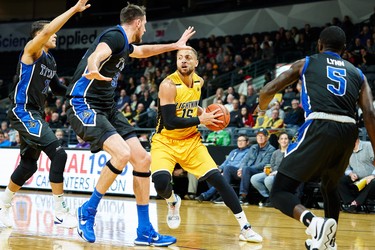 London's Garrett Williamson is guarded by 3 Kitchener's defenders during the first quarter of the Lightning NBL game against the Kitchener Titans in London, Ontario, Friday,  December 21, 2018.
The London Free Press/ Geoff Robins