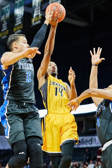 London's Marcus Capers drives to the basket past Kitchener defenders Joel Friesen (l) and Justin Strings during the first quarter of the Lightning NBL game against the Kitchener Titans in London, Ontario, Friday,  December 21, 2018.
The London Free Press/ Geoff Robins