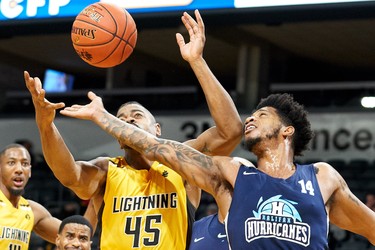 London Lightning's Marvin Phillips (L) and Jordan Washington for the Halifax Hurricanes reach for a loose ball during the first quarter of their NBL game in London Ontario, Thursday, December 20, 2018. (GEOFF ROBINS, Special to The London Free Press)