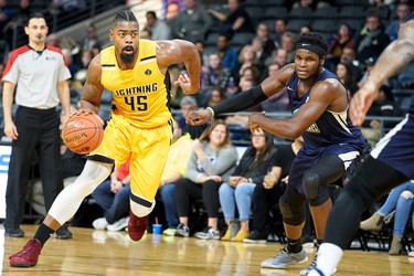 London Lightning's Marvin Phillips drives past Rhamel Brown of the Halifax Hurricanes during the first quarter of their NBL game in London, Ontario, Thursday, December 20, 2018. (GEOFF ROBINS, Special to The London Free Press)