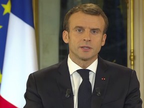 In this frame grab taken from video provided by French TV channel TF1, French President Emmanuel Macron addresses the nation during a live statement at the presidential palace in Paris, France, Monday, Dec. 10, 2018. President Emmanuel Macron broke his silence Monday on the exceptional protests shaking France and his presidency, promising broad tax relief for struggling workers and pensioners — and acknowledging his own responsibility in fueling the nation's anger. (TF1 via AP)