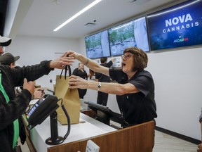 An employee helps a customer with his purchase of legal cannabis in Calgary, Alta., Wednesday, Oct. 17, 2018. THE CANADIAN PRESS/Jeff McIntosh