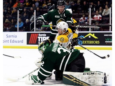 London Knights goalie Joseph Raaymakers makes a save as Knights' William Lochead (4) checks Sarnia Sting's Curtis Egert (23) in the first period at Progressive Auto Sales Arena in Sarnia, Ont., on Wednesday, Dec. 12, 2018. (Mark Malone/Chatham Daily News/Postmedia Network)