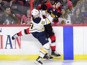 Ottawa Senators defenseman Thomas Chabot (72) gets hit by Buffalo Sabres left wing Remi Elie (81) during second period NHL hockey action in Ottawa on Thursday, Nov. 1, 2018. (THE CANADIAN PRESS/Sean Kilpatrick)