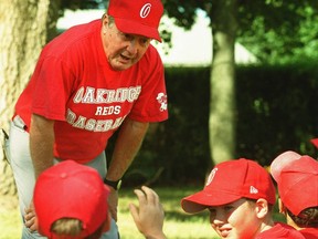 Bob Stark, 71, who has coached Oakridge Optimist baseball and hockey teams for three decades, talks to this year's squad of eight-year-old ball players. (Mike Hensen/London Free Press Mike Hensen/The London Free Press, 2002 file photo)