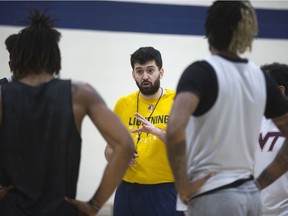 The London Lightning’s new head coach, Elliott Etherington, speaks to players during practice Wednesday. The defending National Basketball League of Canada champs fired coach Keith Vassell, replacing him with one-time Bolts assistant Etherington, who says defence will be the team’s No. 1 priority going forward. (DEREK RUTTAN, The London Free Press)