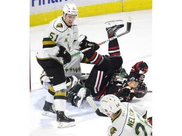 London Knights defenceman Matthew Timms dumps Niagara IceDogs forward Akil Thomas in Jordan Kooy's crease during their game at Budweiser Gardens in London Friday.
Derek Ruttan/The London Free Press