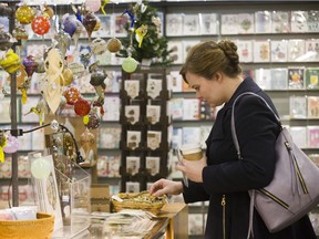 Christina Kaszuba searches for the perfect Christmas gift at Collected Works in the Covent Garden Market on Sunday. "I'm looking for locally made gifts," she said. "If I'm going to be spending lots of money I might as well be helping people in the community." (Derek Ruttan/The London Free Press)