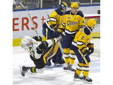 Paul Cotter of the London Knights goes for a spill after being cross-checked by Kurtis Henry of the Erie Otters in the second period of their game at Budweiser Gardens on Sunday. The Knights scored their third goal of the game on the ensuing power play. 

Derek Ruttan/The London Free Press/Postmedia Network