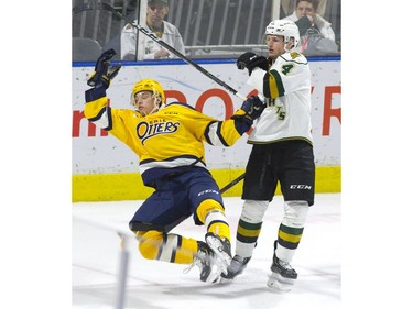 Erie Otters forward Chad Yetman is dumped by London Knights defenceman William Lochead in the third period of their game at Budweiser Gardens on Sunday. Derek Ruttan/The London Free Press/Postmedia Network