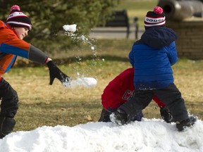 Even though there's not much snow in London this Christmas, the Popescu brothers found enough in Victoria Park for a fraternal snowball fight. Paul, 9 (in orange) was trying to get his little brother Patrick, 5,(Blue) who was in turn trying to hide behind Paul's twin, Peter, (red) with little success. The snow was made up of the scrapings off the skating rink, so it didn't make the best snowballs, but that wasn't enough to slow them down. (Mike Hensen/The London Free Press)