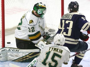 Windsor's Louka Henault tucks one between the legs of Knights goaltender Joseph Raaymakers for the first goal of the game at Budweiser Gardens on Friday December 28, 2018.  Windsor opened the scoring but the Knights came back on goals by Paul Cotter and Nathan Dunkley to lead 2-1 at the first intermission. Mike Hensen/The London Free Press/Postmedia Network