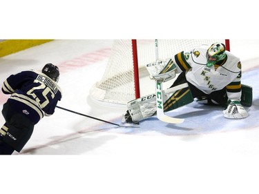 Windsor's Kyle McDonald trys but can't tuck the puck under the legs of Knights goaltender Joseph Raaymakers during their game at Budweiser Gardens on Friday December 28, 2018.  Windsor opened the scoring but the Knights came back on goals by Paul Cotter and Nathan Dunkley to lead 2-1 at the first intermission. Mike Hensen/The London Free Press/Postmedia Network