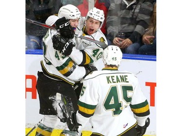 Knights' Paul Cotter and Antonio Stranges celebrate Cotter's first goal to tie up their game against the Spitfires at Budweiser Gardens on Friday December 28, 2018.  Windsor opened the scoring but the Knights came back on goals by Paul Cotter and Nathan Dunkley to lead 2-1 at the first intermission. Mike Hensen/The London Free Press/Postmedia Network