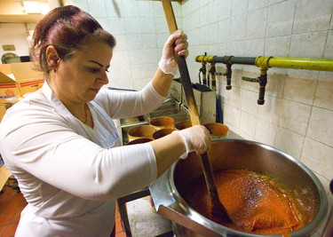 Jomana Homa stirs the pot, literally at the Marconi Club as they prepare tomato sauce for the New Year's Eve meal at London's Marconi Club on Sunday December 30, 2018. 
Joe Strano the general manager expects about 3-400 people will attend their New Year's Eve party at the club.
Mike Hensen/The London Free Press/Postmedia Network