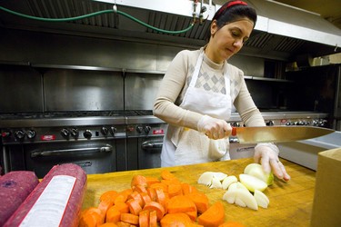 Hala Miarza chops up some fresh veggies for the tomato sauce for the New Year's Eve meal at London's Marconi Club on Sunday December 30, 2018. 
Joe Strano the general manager expects about 3-400 people will attend their New Year's Eve party at the club.
Mike Hensen/The London Free Press/Postmedia Network