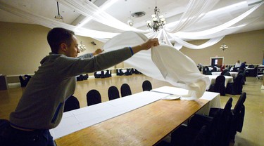 David Bryce, 19 decks the tables with fresh linens at the Marconi Club as they prepare their hall for the New Year's Eve gala at London's Marconi Club on Sunday December 30, 2018. 
Joe Strano the general manager expects about 3-400 people will attend their New Year's Eve party at the club.
Mike Hensen/The London Free Press/Postmedia Network