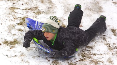 Reece Mathies, 9 tries to stay on his sled as he bumps his way down the hill at Doidge Park on Sunday December 30, 2018. 
Mike Hensen/The London Free Press/Postmedia Network