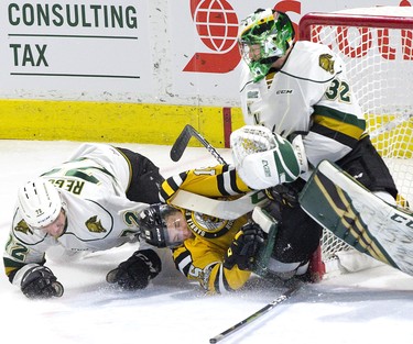 Sarnia Sting forward Calvin Martin crashes into London Knights goalie Joseph Raaymakers after he was hauled down by defenceman Alec Regula  during their OHL game in London, Ont. on Monday December 31, 2018. Derek Ruttan/The London Free Press/Postmedia Network