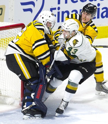 Paul Cotter of the London Knights is shoved into Sarnia Sting goalie Cameron Lamour by defenceman Ashton Ressor during their OHL game in London, Ont. on Monday December 31, 2018. Derek Ruttan/The London Free Press/Postmedia Network