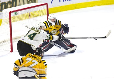 London Knights forward Luke Evangelista reaches out to tip the puck in front of Sarnia Sting goalie Cameron Lamour during their OHL game in London, Ont. on Monday December 31, 2018. Derek Ruttan/The London Free Press/Postmedia Network