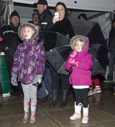 Jesslyn Edyvean and daughters Macky (6) and Emily (4) watch The Magen Boys perform during Start.ca's New Year's Eve a  free, fun and family-friendly event with entertainment and activities for all ages  at Victoria Park in London, Ont. on Monday December 31, 2018.  Derek Ruttan/The London Free Press/Postmedia Network