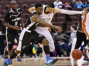 Ottawa Skyhawks' Ryan Anderson battles for a loose ball with Mississauga Powers' Alex Johnson during National Basketball League of Canada action at the Canadian Tire Centre on Wednesday February 12, 2014.