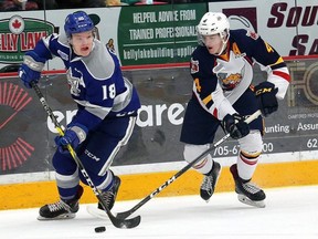 Macauley Carson, left, of the Sudbury Wolves, eludes Joey Keane, of the Barrie Colts, during OHL action at the Sudbury Community Arena in Sudbury, Ont. on Friday January 26, 2018.